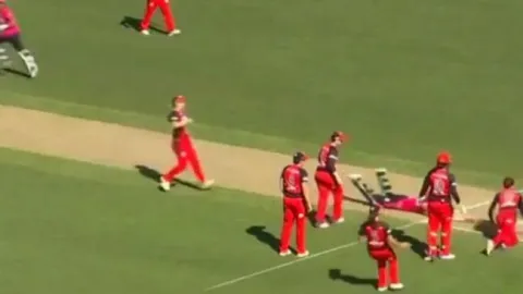 Bowling team forgets to remove bails, batters run on to secure tie - Sakshi