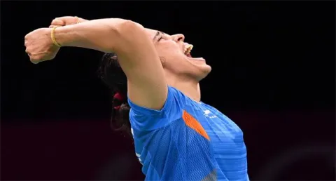 Saina Nehwal Clinches Gold In CWG - Sakshi