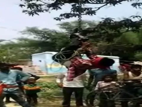Man Beaten And Huge Upside Down For Stealing Mobile Phone  - Sakshi