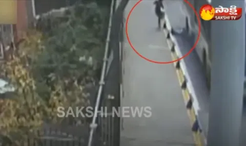 Boy narrowly escapes being run over by bus after tripping over guard rails - Sakshi