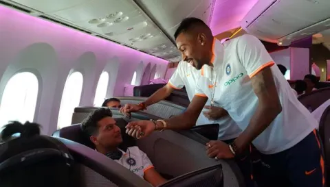 Hardik Pandya interviews Kohli, Dhoni mid-air on flight - Sakshi