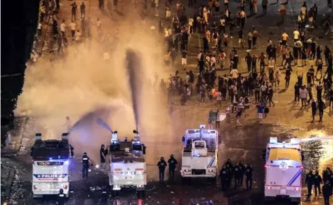 Police fire tear gas after a MILLION French celebrate World Cup  - Sakshi