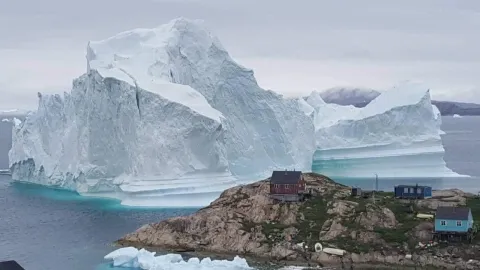 An iceberg as tall as Big Ben is threatening a village in Greenland - Sakshi