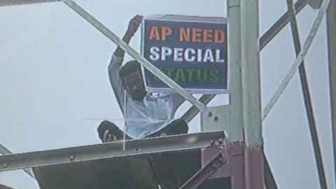 Telangana Youth Climbed Tower To Demand Special Status For AP - Sakshi