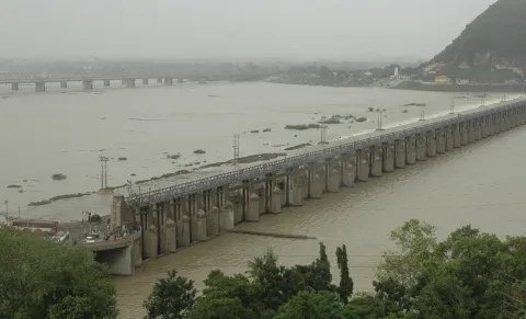 Prakasam Barrage  opens its gates as massive inflows fill barrage - Sakshi