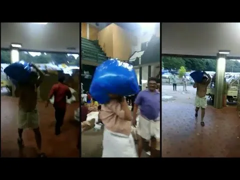  Kerala minister carries flood relief material on shoulders - Sakshi
