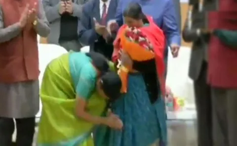 Defence Minister Nirmala Sitharaman touches feet of martyr's mother - Sakshi