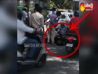 Hyderabad, Bike Rider fall down after sees Traffic police - Sakshi