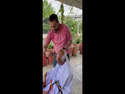 Bandla Ganesh Doing Hair Cutting To His Father