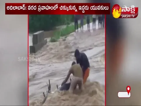 Two Young People Stuck in The Flood Water 