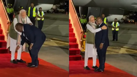 Papua New Guinea PM Touches PM Modis Feet 