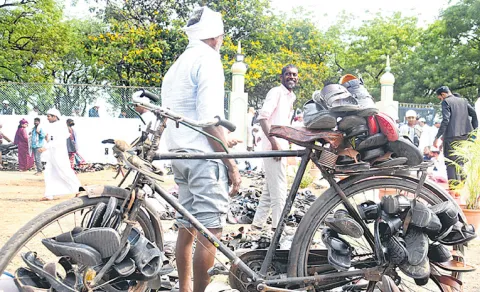 guarding sandals on bicycle at Eidgah in Peddapalli