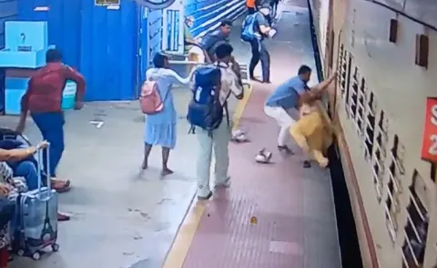 Railway staff saves woman from falling under train in Kerala Ernakulam station