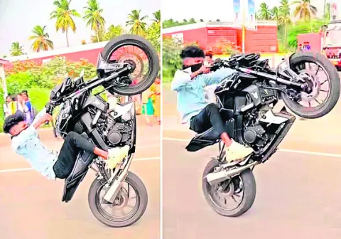 రోడ్డులో బైక్‌పై యువకుడి విన్యాసం 