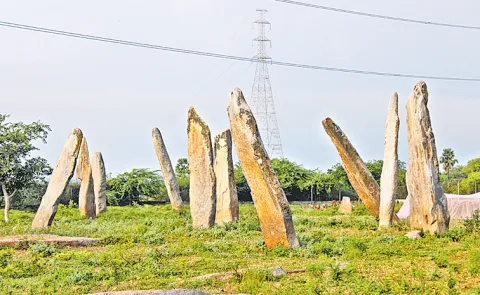 Power grid towers in the courtyard of the prehistoric monuments in Mudumaal