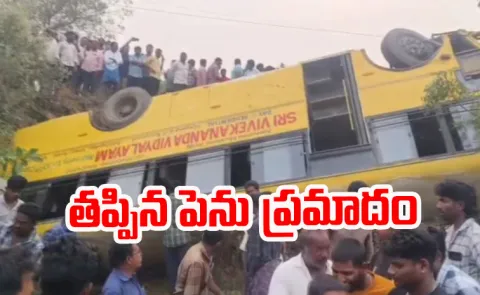 Bus overturns into canal Khammam District