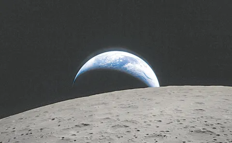 Earthset and a solar eclipse: Nasa releases first images from Moon fly-by