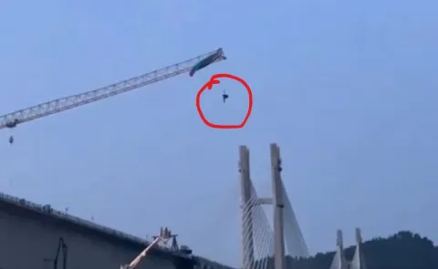 Paraglider Dangles 60 Metres In Air After Getting Stuck On Crane In China