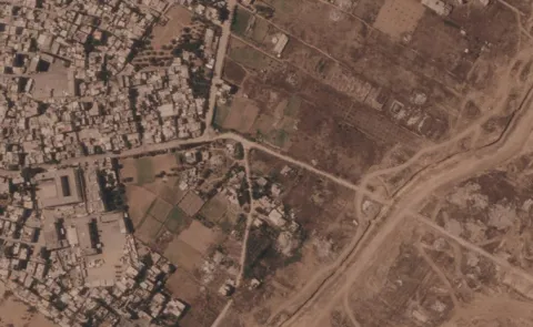 Israel is building a miles-long earthen barrier inside Gaza