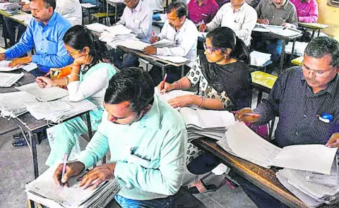 Another school teacher is responsible for marking the answer sheets