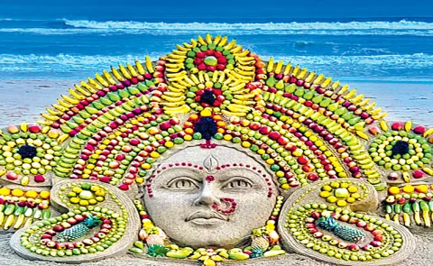 Sand artist Sudarsan Pattnaik creates on a sand sculpture of GoddessDurga