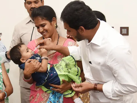 CM YS Jagan Gives Polio Drops To A Child In Camp Office - Sakshi