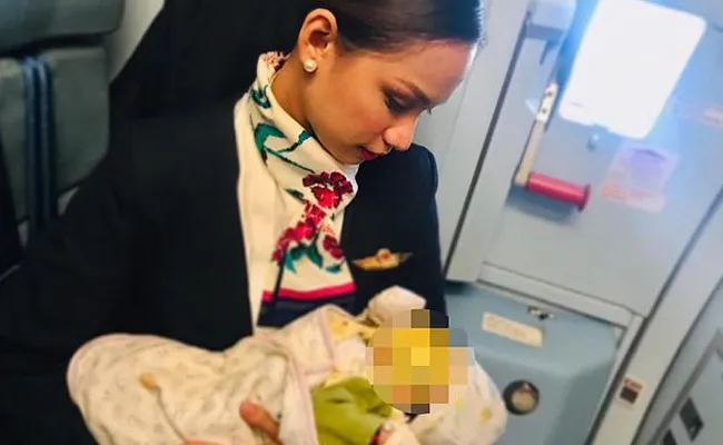 Air Hostess Breastfeeds A Strangers Crying Baby - Sakshi