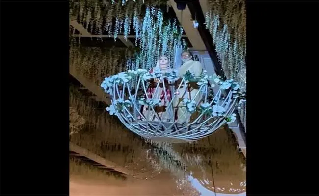 Bride Entering Wedding Hall On Platform Suspended From Ceiling - Sakshi