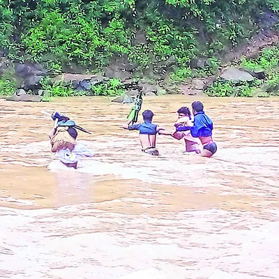 నిత్యావసర సరకుల కోసం వాగు దాటాల్సిందే