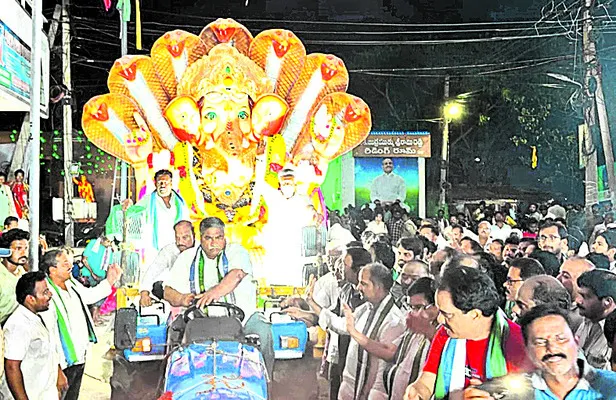  Former MP Modugula Venugopalapal Reddy driving a tractor during the immersion ceremony held in Tadepalli.