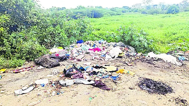 Piles of garbage on the side of the road in Ramayampet town