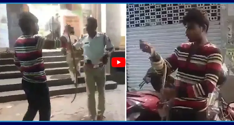 చేతిలో పాముతో తాగుబోతు హుల్చుల్