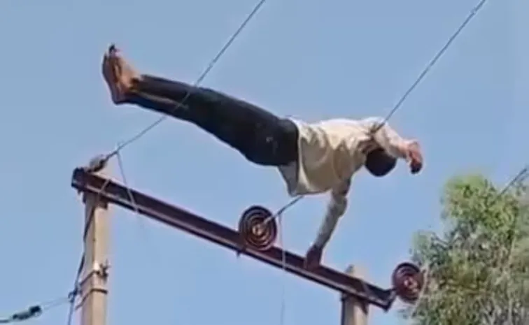 Drunken man bizarre stunt a top an high volt electricity pole in uttar pradesh