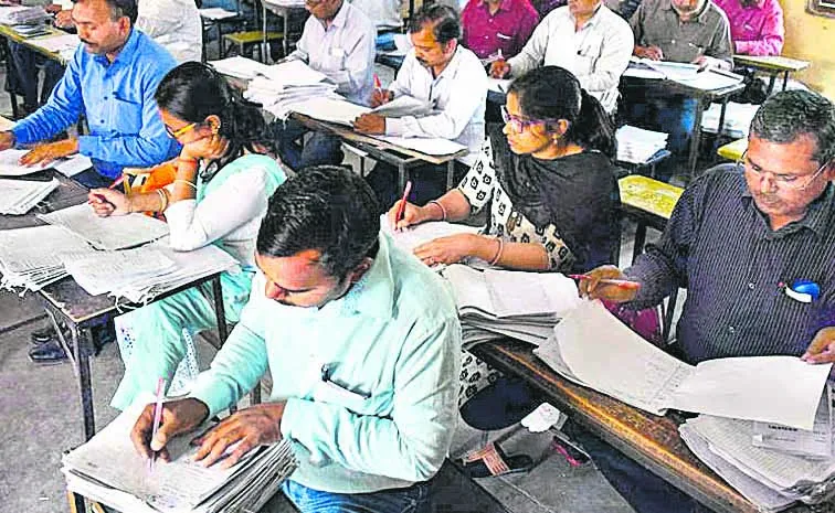 Another school teacher is responsible for marking the answer sheets